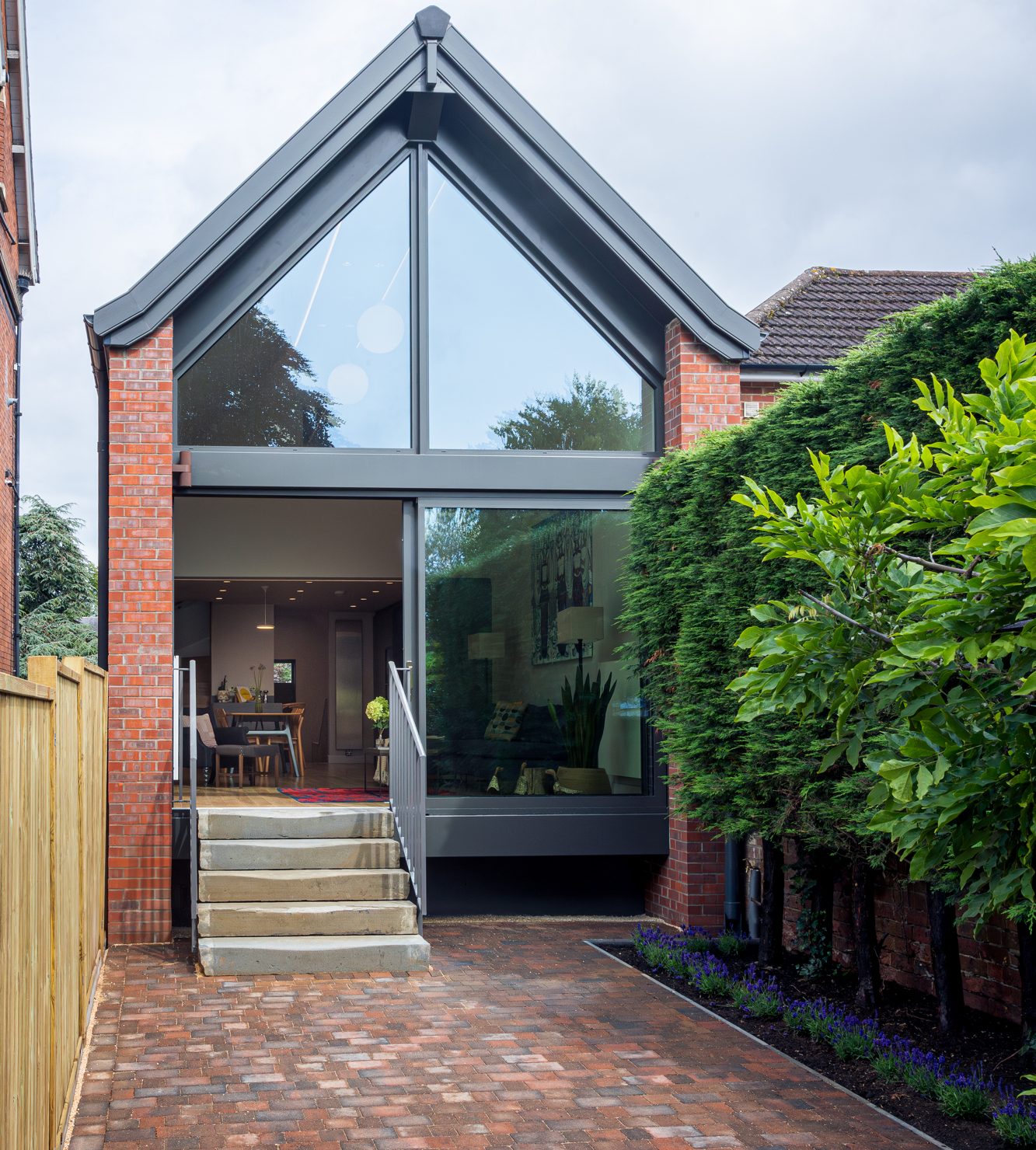 Rear of property with glass windows from floor to roof